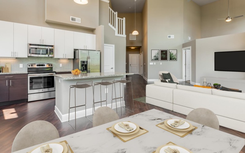 a dining room with a table and chairs and a kitchen beyond it