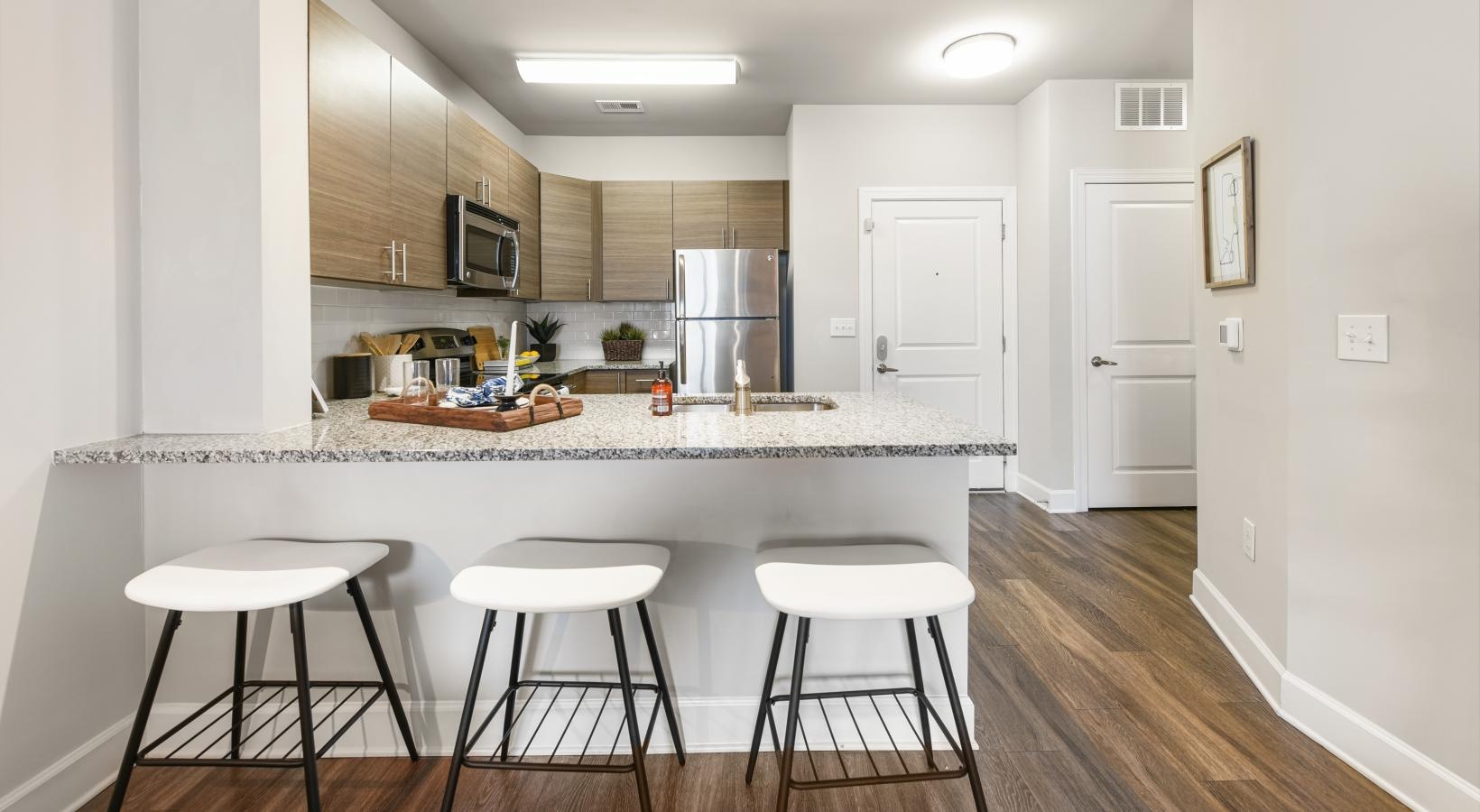 a kitchen breakfast bar with a bar stools